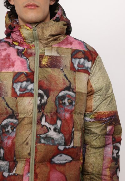 Puffer jacket featuring a patchwork design with abstract patterns in shades of pink, red, gold, and gray; includes a hood and front zipper.