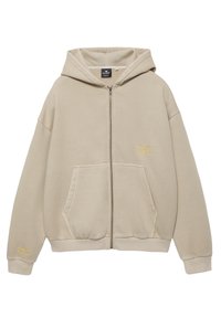 Beige Kapuzen-Sweatshirt mit Reißverschluss, Vorderentaschen, gerippten Bündchen und gelber Textstickerei auf Brust und Ärmel.