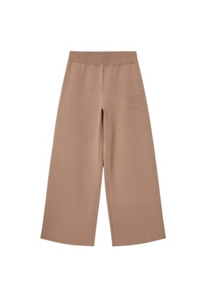 Beige vida byxor med strukturerad yta, med en mjuk elastisk midjeresår och broderad "AS"-detalj på vänster höft.