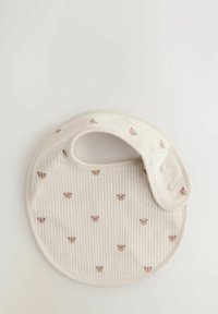Light beige bib with ribbed texture, features small brown bear face patterns, and a snap closure on the side. Soft cotton material.