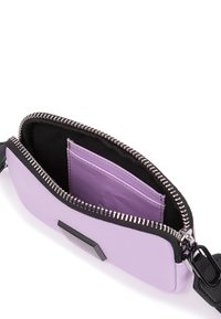 Zip wallet in lavender leather with a black fabric interior. Features a card slot and metallic zip detailing. Rectangular shape with a thin strap.