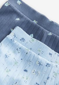 Tre paia di calze da donna in tonalità di blu: blu navy a coste, blu chiaro con motivo floreale e strisce blu, tutte realizzate in tessuto morbido.