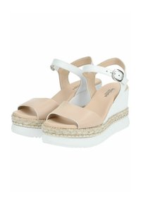 Sandales compensées beiges avec une sangle blanche, semelle intermédiaire en espadrille texturée et un design à bout ouvert. Présentant une accent en boucle métallique argentée.
