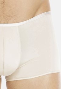 Beige men's boxer briefs with a smooth texture, elastic waistband, and subtle stitching details. Designed for comfort and fit.