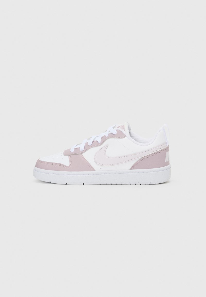 Light pink and white sneaker made of leather and mesh, featuring a textured design, round toe, and flat white sole with logo accents.