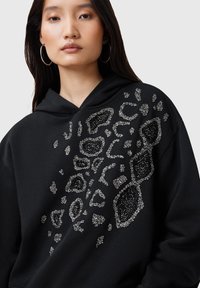 Felpa nera con cappuccio caratterizzata da un design in stampa leopardata argentata a rilievo sulla parte anteriore, con cappuccio e vestibilità rilassata.
