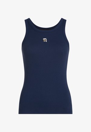 Mornarsko modra brezrokavnik z rebrasto tkanino, okrogel izrez in majhen vezen obraz s sončnimi očali in belimi lasmi na sredini prsnega koša.