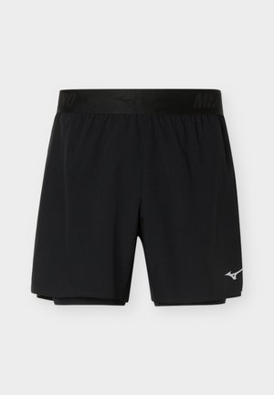 Shorts de sport noirs avec taille élastique et couche de compression intérieure, arborant un petit logo blanc Mizuno sur la partie inférieure de la jambe droite.
