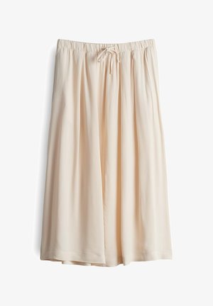 Jupe midi beige clair avec une coupe décontractée, fabriquée en tissu doux. Elle présente une taille élastique et des plis avant pour plus de volume.