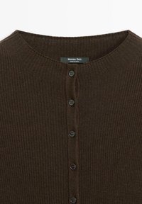 Brown ribbed cardigan featuring a round neckline, front buttons, and a smooth texture. Brand label "Massimo Dutti" located at the collar.