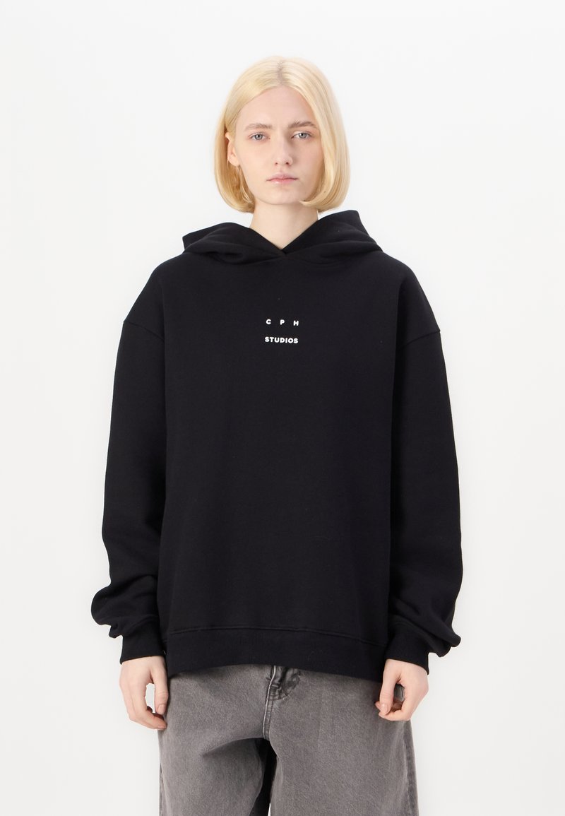 Black hooded sweatshirt with a loose fit, featuring white text “C P H STUDIOS” on the front. Soft fabric with ribbed cuffs and hem.