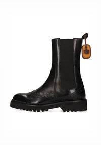 Botín de cuero negro con paneles elásticos laterales, detalles decorativos de brogue, suela robusta y una etiqueta de cuero en la tira de extracción.