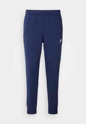 Tumedama sinine Nike treeningpüksid, mis on valmistatud pehmest puuvillasegust, millel on elastne vöökoht, kitsenevad sääred ja väike valge logo küljel.