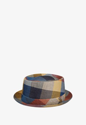Multicolored plaid fabric bucket hat with a short brim and a small round metal logo on the side.