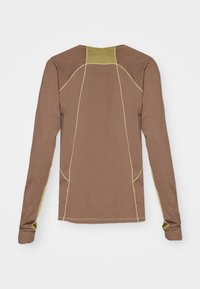Brown long-sleeve shirt with contrasting yellow stitching, featuring a rounded neckline and fitted sleeves. Soft fabric, no distinct patterns.