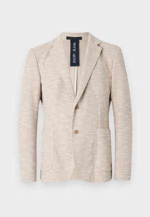 Beige Blazer aus strukturiertem Stoff, mit Reverskragen, zwei Knöpfen und zwei Vorderentaschen. Markenlabel sichtbar innen.