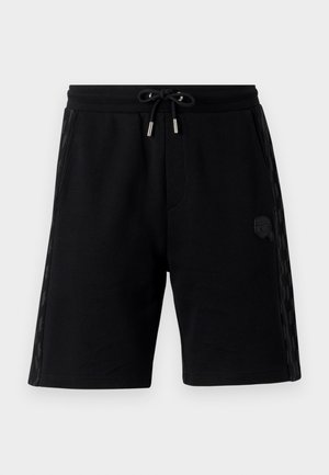 Sorte svedshorts med justerbar talje, sidelommer, strukturerede sidepaneler og et lille logodesign. Fremstillet af blødt stof.