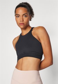 Nike Performance TWIST BRA - Sutiã desportivo de suporte ligeiro - black