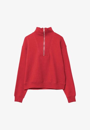 Červený dlouhý rukáv s vysokým límcem a stříbrným zipem vpředu, který sahá do poloviny hrudníku.