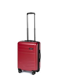 Valigia rigida rossa con un design elegante, superficie testurizzata, maniglia retrattile nera e ruote che scorrono in modo fluido. Etichetta del marchio visibile.