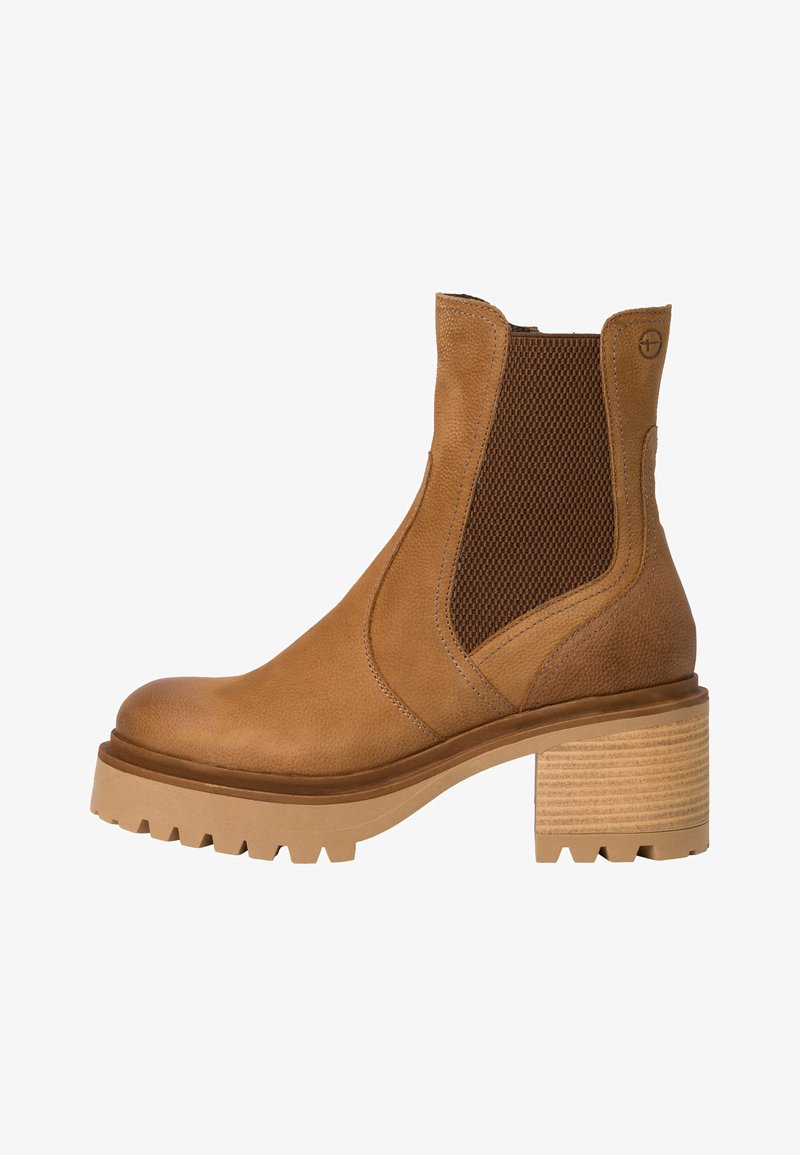 Tan leather ankle boot with textured side panels, a chunky heel, and a rubber sole featuring tread for grip. Smooth finish and elegant design.