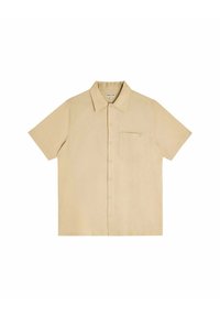 Chemise beige à manches courtes en tissu léger. Dotée d'un col boutonné, d'une poche sur la poitrine gauche et d'un petit logo.