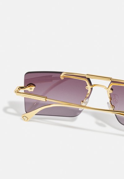 Gold-tone sunglasses with rectangular purple lenses. Features a metal frame, adjustable nose pads, and a branded side accent.