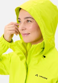 Giacca impermeabile gialla brillante con cappuccio, zip frontale e polsini elasticizzati. Presenta cappuccio regolabile e dettaglio del logo sul petto.