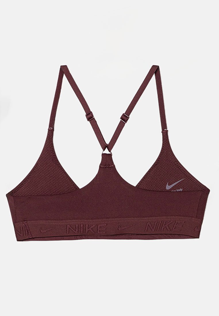 Top sportivo bordeaux con pannelli in rete, spalline regolabili e ampia banda elastica con logo "NIKE" in rilievo. Design minimalista con chiusura posteriore.