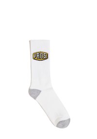 Calcetín de algodón blanco con textura acanalada, acentos en gris en el talón y la puntera, que presenta un logo "VANS" en negro y amarillo en el lado superior.