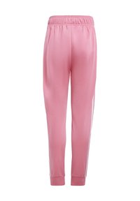 Pink athletic pants, made of smooth fabric, featuring an elastic waistband, tapered fit, and white stripes along the sides.