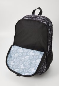 Black backpack with floral pattern, featuring a blue interior lining with leaf motifs. Zipper closure and sturdy fabric material.