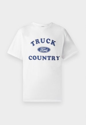 White cotton t-shirt featuring blue printed text "TRUCK COUNTRY" with a blue oval "Ford" logo in the center. Short sleeves and crew neckline.