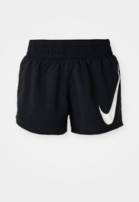 Shorts de sport noirs avec une taille élastique, présentant un grand logo Nike blanc à l'avant et fabriqués dans un tissu lisse et léger.