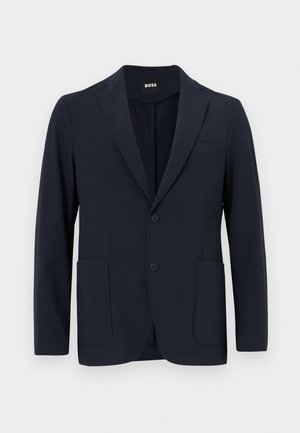 Navy zila žakete izgatavota no viegla auduma, ar izgriezumu, divām priekšējām kabatām un diviem pogu aizdariem.