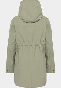 Khaki-grön parkas med huva, åtdragen midja, långa ärmar och en mjuk textur. Har dold sömnad och tryckknappar på ärmarna.