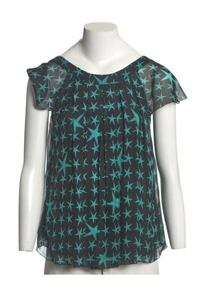 Schwarze transparente Bluse mit kurzen Volantärmeln und türkisfarbenem Sternmuster auf einem weißen Schaufensterpuppen-Torso.