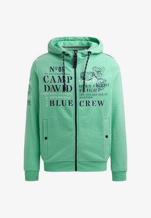 Mintgrüner Reißverschluss-Hoodie aus weichem Material. Verfügt über schwarze Textgrafiken, eine Kordelzugkapuze und zwei Vorderseiten-Taschen mit Druckknopfverschlüssen.