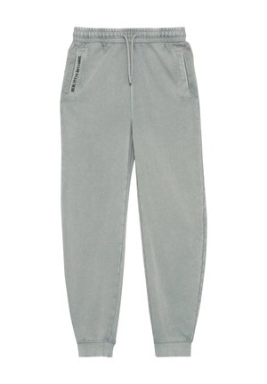 Pantalon de jogging gris clair en tissu doux, doté d'une taille élastique avec cordon de serrage, de poches latérales et de poignets ajustés.