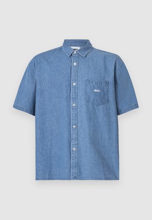Short-sleeve blue denim shirt with button-up front, collar, and left chest pocket featuring an embroidered logo. Soft texture, casual fit.