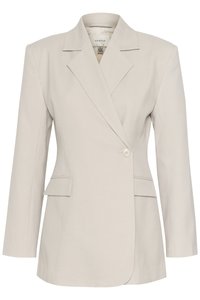 Lys beige skreddersydd blazer med klaffelapp, enkel knappelukking og to frontlommer. Glatt stoff med strukturert design.
