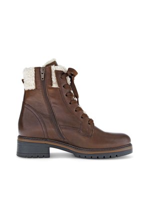 Brown leather ankle boot with side zipper, lace-up front, shearling cuff, and chunky black rubber sole.