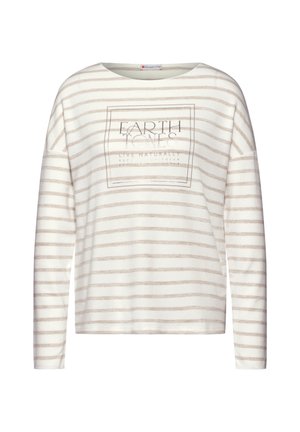 Långärmad topp i gräddfärgad med beiga horisontella ränder, med en tryckt design som säger "EARTH TONES LIVE NATURALLY" i mitten.