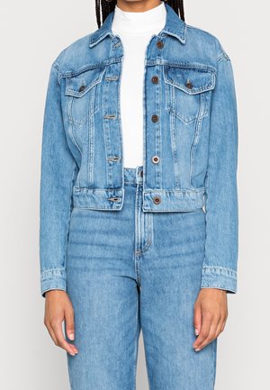 Light blue denim jacket with a cropped design, button closures, and two chest pockets. It features classic stitching and a slightly faded texture.