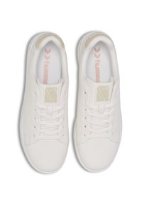 Valged sneakersid, millel on sile sünteetilisest nahast pealis, lamedad nöörid, perforeeritud detailid ja diskreetne logo keelel.