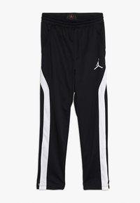 Černé sportovní kalhoty s bílými bočními pruhy, elastickým pasem a logem Jumpman. Vyrobené z hladkého, lehkého materiálu pro maximální komfort.