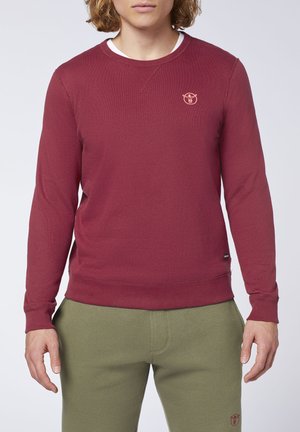Maroon pullover sweatshirt with long sleeves, round neck, and a small logo on the chest. Soft fabric and ribbed cuffs and hem.