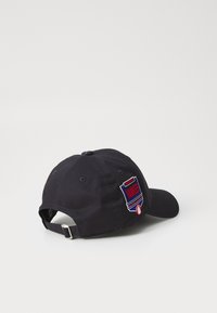 Black baseball cap with adjustable strap, featuring a colorful embroidered "Yankees" logo on the back, cotton material, structured design.