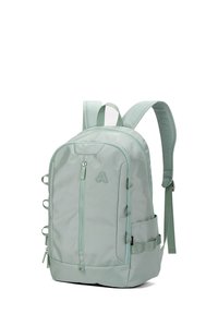Sac à dos vert menthe en tissu durable, avec une poche zippée à l'avant, des boucles latérales, des bretelles rembourrées et une poignée supérieure.