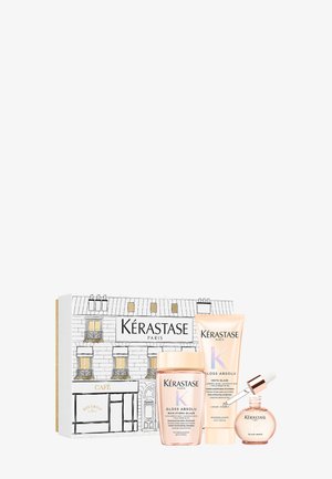 Kérastase geschenkset in een decoratieve doos, met lichtroze glansshampoo, conditioner en serum. Inclusief geïllustreerd ontwerp van een Parijse café.